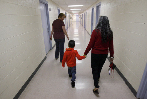 Francisco Kjolseth  |  The Salt Lake Tribune
Downy Bowles, left, case manager for Linda Martinez Brown, holding the hand of Carmin Martinez, 4, his grandson, walk the halls of the Road Home Homeless shelter in Salt Lake. Brown, who is often referred to as "grandma" by other kids at the shelter, usually has several kids with her throughout the day.