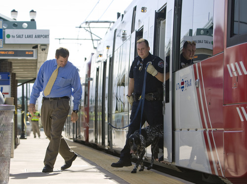 Kim Raff  |  The Salt Lake Tribune
West Valley City Police use police dogs to sniff around TRAX train cars while investigating a shooting in and around the West Valley City Police Department and the West Valley Central TRAX platform in West Valley City on April 29, 2013. No police were injured and James Ramsey Kammeyer was taken into custody.