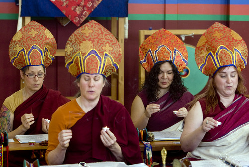 Kim Raff  |  The Salt Lake Tribune
Members of the Urgyen Samten Ling Buddhist temple hold candles and incense during a ceremony in Salt Lake City on April 21, 2013. The building was once a Mormon ward and a gothic nightclub before it was renovated and became a Buddhist temple.