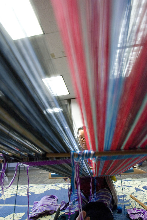Paul Fraughton  |  The Salt Lake Tribune
Paw Laweh demonstrates traditional Burmese weaving at the opening of The University Neighborhood Partners' new Hartland Partnership Center at 1578 W. 1700 South.