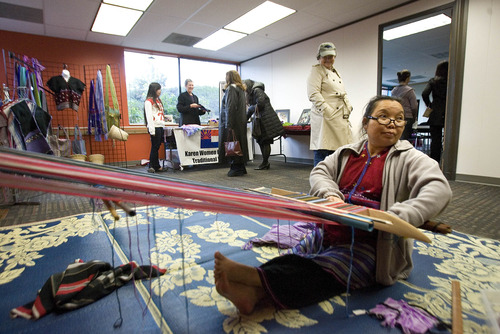 Paul Fraughton  |  The Salt Lake Tribune
Paw Laweh demonstrates traditional Burmese weaving at the opening of The University Neighborhood Partners' new Hartland Partnership Center at 1578 W. 1700 South.
 Tuesday, April 16, 2013
