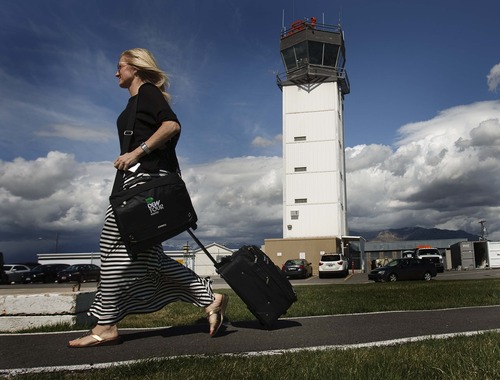 Leah Hogsten  |  The Salt Lake Tribune
An airline passenger arrives at  Ogden-Hinckley Airport April 5, 2013.  The air traffic control tower at right is scheduled to close due to sequestration. The Federal Aviation Administration recently issued a list of 173 small- and medium-size airports that will face control tower closures because of forced spending cuts. Airports in Ogden and Provo are the only two in Utah on the chopping block.
