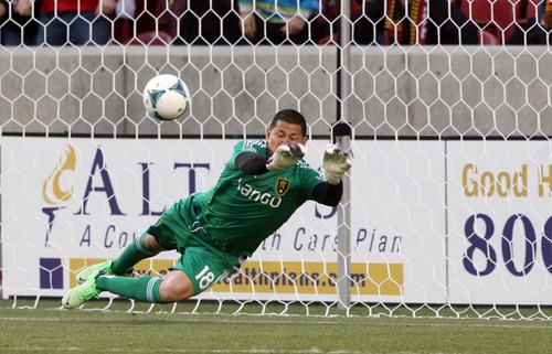 Kim Raff  |  The Salt Lake Tribune
Real Salt Lake goalkeeper Nick Rimando (18) makes a diving save during a penalty kick by Chivas USA midfielder Edgar Mejia (8) during the first half of a game at Rio Tinto Stadium in Sandy on April 20, 2013.