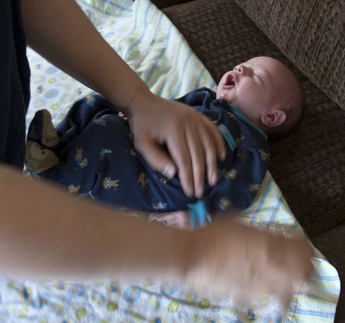 Steve Griffin | The Salt Lake Tribune

Megan Richardson swaddles her newborn son, Charlie, at their West Valley City, Utah home Wednesday May 1, 2013.