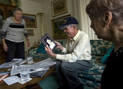 Kim Raff  |  The Salt Lake Tribune
(left) Alice Telford watches as (middle) Bill Gillingham admires the photo she gave him of her son, John W. Telford. Telford lost her son, John, in the Vietnam War. Bill Gillingham, John's old friend, contacted Alice Telford after he saw her in the Salt Lake Tribune back in February. He'd tried to find her since learning of John's death many years ago. He was grateful to receive the photograph since he didn't have any pictures of John.