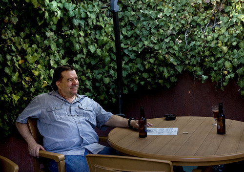 Kim Raff  |  The Salt Lake Tribune
Bruce Larsen sits with friends on the patio of The Hog Wallow Pub in Salt Lake City on April 26, 2013.