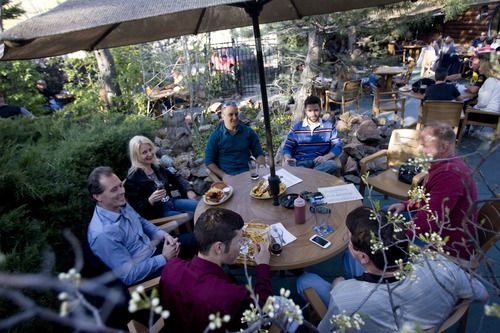 Kim Raff  |  The Salt Lake Tribune
Friends share drinks and eat food around a large table on the patio of The Hog Wallow Pub in Salt Lake City on April 26, 2013.