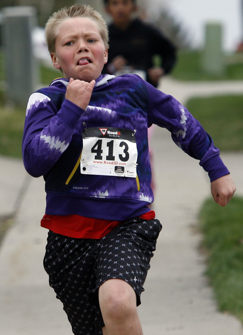 Rick Egan  | The Salt Lake Tribune 

Eleven-year-old, Cole Wardle, on the home stretch of the 1-mile run, at the Tulip Trot fundraiser for Muir Elementary in Bountiful, Saturday, April 13, 2013.