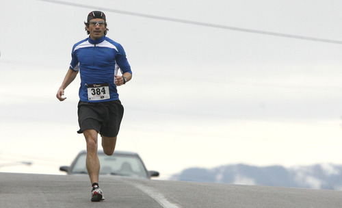 Rick Egan  | The Salt Lake Tribune 

Nephi Sanchez, on the home stretch of  the 5K race, at the Tulip Trot fundraiser for Muir Elementary. Saturday, April 13, 2013.  Mortensen was the over all winner of the 5K race.