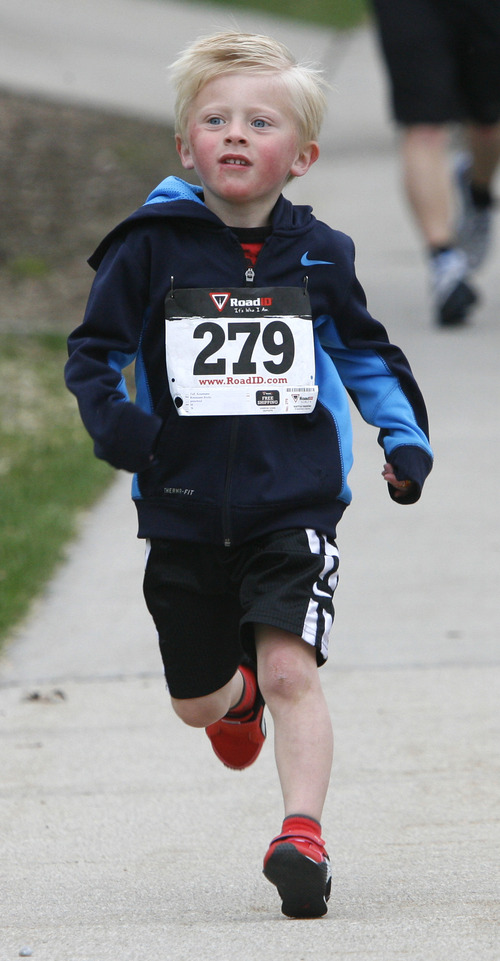 Rick Egan  | The Salt Lake Tribune 

Five-year-old Taft Roseman, comes down the home stretch, of the 5K race, at the Tulip Trot fundraiser for Muir Elementary. Saturday, April 13, 2013.   Taft took first place in the preschool division.