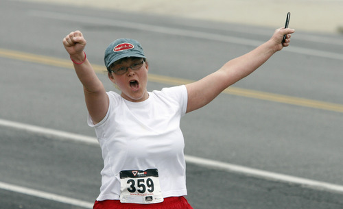 Rick Egan  | The Salt Lake Tribune 

Krista Smith celebrates as she nears the finish line of the 5K race, at the Tulip Trot fundraiser for Muir Elementary. Saturday, April 13, 2013.
