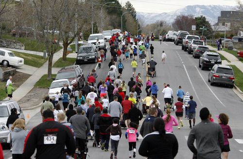 Rick Egan  | The Salt Lake Tribune 

Runners make their way up Davis Blvd, during the Tulip Trot fundraiser for Muir Elementary in Bountiful, Saturday, April 13, 2013.