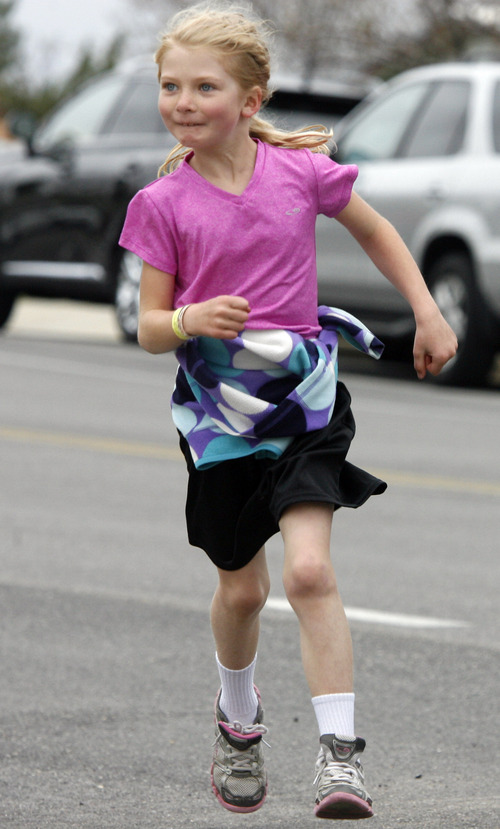 Rick Egan  |  The Salt Lake Tribune
Six-year-old Lexie Lee smiles as she rounds the corner of the finish line, in the 1-mile race, at the Tulip Trot fundraiser for Muir Elementary in Bountiful, Saturday, April 13, 2013.