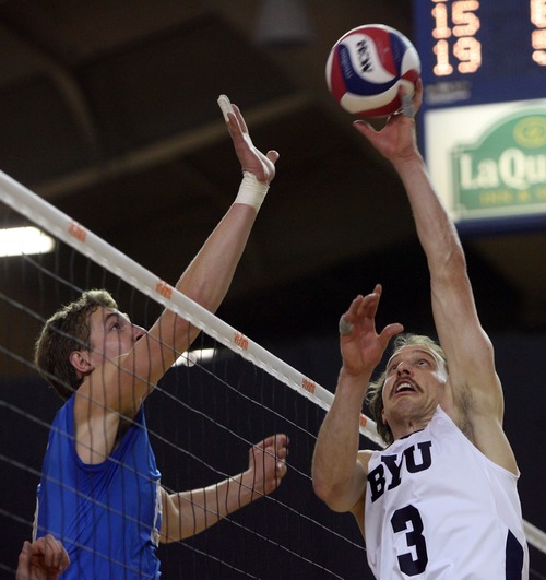 Kim Raff  |  The Salt Lake Tribune
(right) BYU player Ryan Boyce tips the ball over the net as (left) UCLA player Robart Page defends in the semifinals of the MPSF Volleyball Tournament at the Smith Fieldhouse in Prove on April 25, 2013. BYU went on to win the match 3-2 after being down two sets.