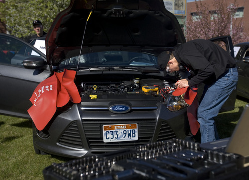 Kim Raff  |  The Salt Lake Tribune
Provo High School student Jimmy Hicken works under the hood of a vehicle during the Ford/AAA Student Auto Skills competition on the Miller Campus of Salt Lake Community College in Sandy on May 2, 2013.  Automotive technology students from twenty of Utah's high schools compete with each other in debugging cars in a timed competition.  The winner will travel to Ford's Headquarters in Dearborn, MI for the national finals.