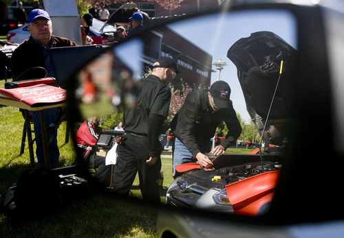 Kim Raff  |  The Salt Lake Tribune
Provo High School students (left) Parker Thomas and Jimmy Hicken are reflected in a side view mirror as they work under the hood of a vehicle during the Ford/AAA Student Auto Skills competition on the Miller Campus of Salt Lake Community College in Sandy on May 2, 2013.  Automotive technology students from twenty of Utah's high schools compete with each other in debugging cars in a timed competition.  The winner will travel to Ford's Headquarters in Dearborn, MI for the national finals.
