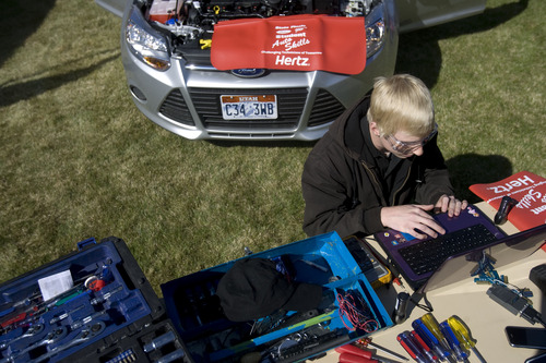 Kim Raff  |  The Salt Lake Tribune
Woods Cross High School student Steven Allcott works on a computer to try and debug a car during the Ford/AAA Student Auto Skills competition on the Miller Campus of Salt Lake Community College in Sandy on May 2, 2013.  Automotive technology students from twenty of Utah's high schools compete with each other in debugging cars in a timed competition.  The winner will travel to Ford's Headquarters in Dearborn, MI for the national finals.