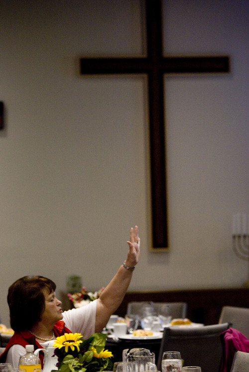 Kim Raff  |  The Salt Lake Tribune
Vickie Fuller holds her hand in the air and sings along Thursday during a worship service for the 62nd National Day of Prayer at Calvary Chapel of Salt Lake. The event featured live-streaming video from the National Day of Prayer event, a free breakfast and a worship service.