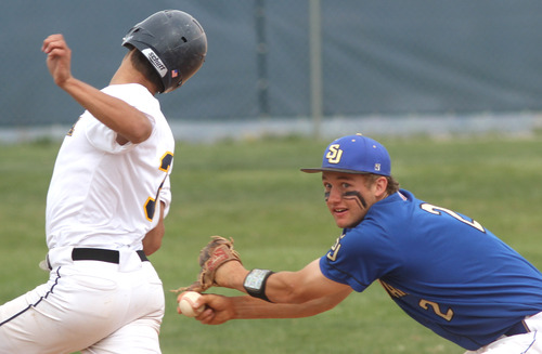 Rick Egan  | The Salt Lake Tribune 

Ryan Williamson (3), Summit Academy, is tagged out by San Juan's Barkley Christensen (2), in prep 2A playoff action, Saturday, May 4, 2013.