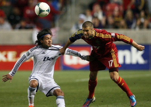 Kim Raff  |  The Salt Lake Tribune
(left) Vancouver Whitecaps FC midfielder Daigo Kobayashi (14) is held back by (right) Real Salt Lake defender Chris Wingert (17) as he heads the ball during a match at Rio Tinto Stadium in Sandy on May 4, 2013.  Real Salt Lake went on to win the game 2-0.