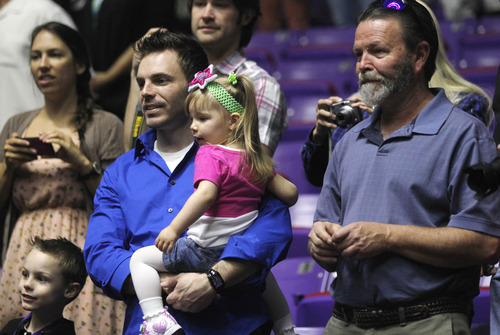 Al Hartmann  |  The Salt Lake Tribune
Jen Carver Comer's son, T.J., left, husband Daniel Comer, stepdaughter Scarlett and grandfather Bill Comer watch her march into the Dee Events Center to receive two degrees from Weber State University on April 26.