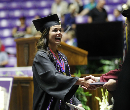 Al Hartmann  |  The Salt Lake Tribune
Jen Carver Comer shakes hands with a faculty member upon receiving one of her two degrees from Weber State University Friday, April 26.