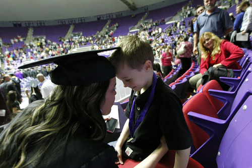 Al Hartmann  |  The Salt Lake Tribune
Jen Carver Comer, returned Iraq war veteran, shares a quiet moment with her son  T.J., 5, after the Weber State University graduation cermemony where she received with two degrees Friday April 26.