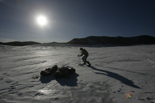 Rick Egan   |  The Salt Lake Tribune

Mickey Anderson drills a hole in the ice as he prepares to go ice fishing at Panguitch Lake,  Monday, January 4, 2010