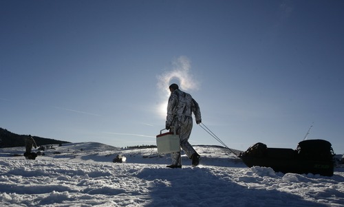 Rick Egan   |  The Salt Lake Tribune

It is so cold that George Sommer's breath hovers around his head, as he pulls his sled full of fishing equipment onto the ice,as he prepares to go ice fishing at Panguitch Lake,  Monday, January 4, 2010