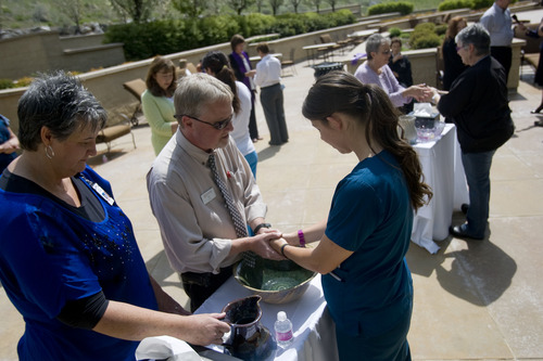 Kim Raff  |  The Salt Lake Tribune
(right) Nickole (cq) Canfield, a health care assistant, has her hands blessed by (middle) Wes Wilde, a chaplain from Summit Home Health, and (left) Irene Huntsman, a spiritual care volunteer, during the "Blessing of the Hands" on the outdoor patio of the Huntsman Cancer Institute in Salt Lake City on May 6, 2013. The event gathered a diverse group of spiritual care providers to bless hospital caregivers, employees and patrons.