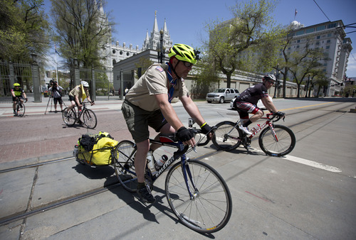 Lennie Mahler  |  The Salt Lake Tribune
Dave McGrath mounts his cycle in front of the LDS Temple in Salt Lake City, Utah, Sunday, May 5, 2013. Dave and his son, Joe, are riding 1,800 miles from Idaho to the Boy Scouts of America National Meeting in Irving, Texas, to demonstrate against the BSA ban on gay scout leaders.