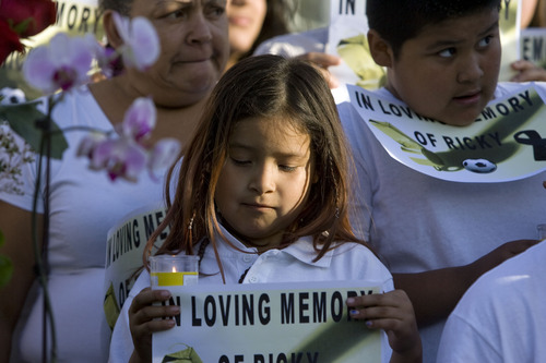 Kim Raff  |  The Salt Lake Tribune
Friends and family hold signs and candles during a news conference Sunday in Salt Lake City by the family of soccer referee Ricardo Portillo, who died Saturday of injuries he sustained when police say a player punched him in the head during a game.