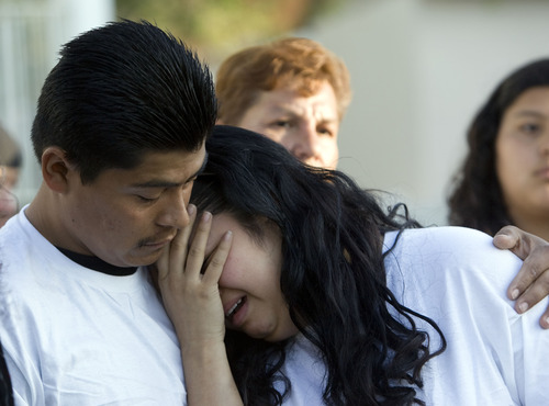 Kim Raff  |  The Salt Lake Tribune
Johana Portillo-Lopez, daughter of soccer referee Ricardo Portillo, is comforted by Juan Munoz after speaking Sunday about her father's death during a news conference in Salt Lake City. Portillo died Saturday, a week after police say a teenage player punched him in the head during a game.