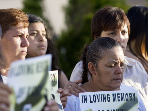 Friends and family hold signs and candles during a news conference to talk about the death of Ricardo Portillo, who passed away after injuries he sustained after an assault by a soccer player at a soccer game he was refereeing on April 27, in Salt Lake City on Sunday, May 5, 2013. (AP Photo/The Salt Lake Tribune, Kim Raff)