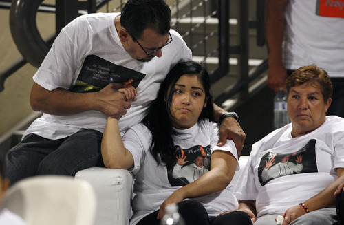 Scott Sommerdorf   |  The Salt Lake Tribune
Marco Martinez, left, supports Johana Portillo-Lopez, the daughter of Ricardo Portillo, the soccer ref who died after being punched during a soccer match, at the public viewing/memorial for Ricardo Portillo, Wednesday, May 8, 2013. At right is Bertha Portillo, the sister of Ricardo Portillo.