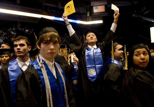 Kim Raff  |  The Salt Lake Tribune
(back middle) Tony Zhang waves to people in the audiences during the processional at the Salt Lake Community College Commencement Program at the Maverik Center in West Valley City on May 9, 2013.