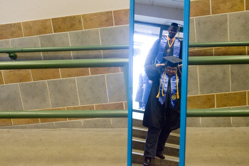 Kim Raff  |  The Salt Lake Tribune
Graduates are reflected in a mirror as they make their way into the Maverik Center during the processional at the Salt Lake Community College Commencement Program in West Valley City on May 9, 2013.