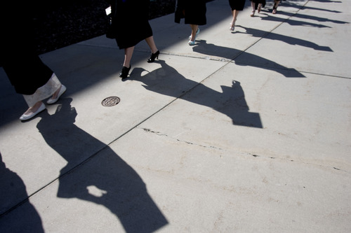 Kim Raff  |  The Salt Lake Tribune
Graduates shadows appear on the ground as they make their way into the Maverik Center for the processional during the Salt Lake Community College Commencement Program in West Valley City on May 9, 2013.