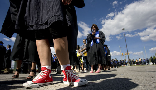 Kim Raff  |  The Salt Lake Tribune
Teena (cq) Brown sports red Converse All Star high tops under her graduation gown as she lines up with her classmates for the processional into the Maverik Center during the Salt Lake Community College Commencement Program in West Valley City on May 9, 2013.