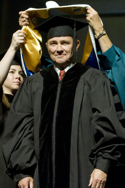 Kim Raff  |  The Salt Lake Tribune
Utah Gov. Gary H. Herbert is presented with an honorary doctorate degree during the Salt Lake Community College Commencement Program at the Maverik Center in West Valley City on May 9, 2013.