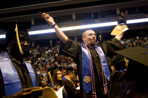 Kim Raff  |  The Salt Lake Tribune
Jeremy Norton waves to people in the audiences during the processional at the Salt Lake Community College Commencement Program at the Maverik Center in West Valley City on May 9, 2013.