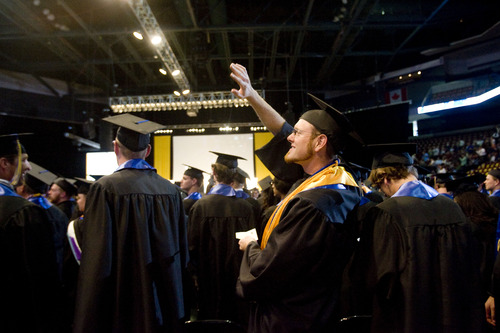 Kim Raff  |  The Salt Lake Tribune
Chris Kruse waves to people in the audiences during the processional at the Salt Lake Community College Commencement Program at the Maverik Center in West Valley City on May 9, 2013.