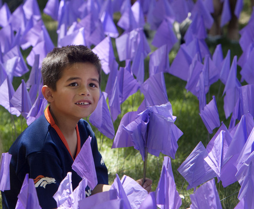 Steve Griffin  |  The Salt Lake Tribune
Michael, Torrez, 7, sits in a sea of purple flags on the grounds of the City and County Building during the Utah Foster Care's March for Kids down State Street in Salt Lake City Friday May 10, 2013. Foster families were joined by police officers and firefighters as they celebrate National Foster Care Month. Michael's foster mother, Jennifer Larkin was honored as Salt Lake Valley's Foster Care Mother of the Year during the event.