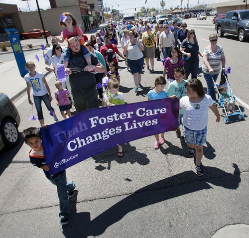 Steve Griffin  |  The Salt Lake Tribune
Foster kids Michael, 7, and Ashya, 9, carry a banner as they lead the Utah Foster Care's March for Kids down State Street in Salt Lake City Friday May 10, 2013. Foster families were joined by police officers and firefighters as they celebrate National Foster Care Month. The Torrez children's mother, Jennifer Larkin, was honored as Salt Lake Valley's Foster Care Mother of the Year during the event.
