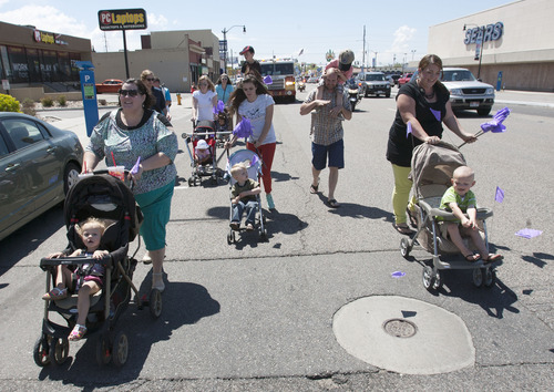 Steve Griffin  |  The Salt Lake Tribune
Foster care families push the younger children in strollers during the Utah Foster Care's March for Kids down State Street in Salt Lake City Friday May 10, 2013. Foster families were joined by police officers and firefighters as they celebrate National Foster Care Month.
