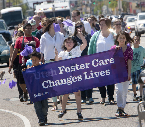 Steve Griffin  |  The Salt Lake Tribune
Foster kids Michael, 7, Ashya, 9, and Alyssa Torrez, 12, carry a banner as they lead the Utah Foster Care's March for Kids down State Street in Salt Lake City Friday May 10, 2013. Foster families were joined by police officers and firefighters as they celebrate National Foster Care Month. The Torrez children's mother, Jennifer Larkin, back right, was honored as Salt Lake Valley's Foster Care Mother of the Year during the event.