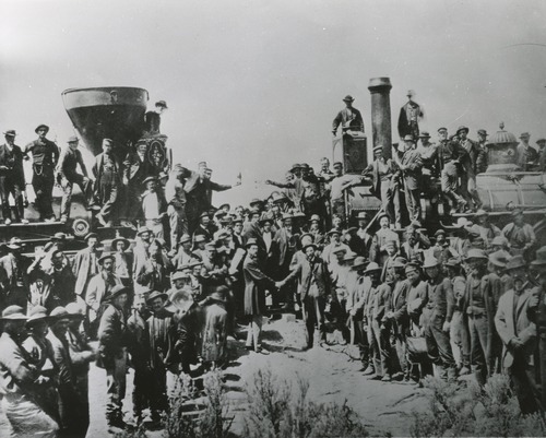 Tribune file photo

This is the most famous photograph taken of the "Last Spike" Ceremony at Promontory, May 10, 1869, with Central Pacific locomotive "Jupiter", CP No. 60, a wood-burner, on the left, and Union Pacific locomotive No. 119, a coal-burner on the right. The engineers of these two locomotives are on the pilots holding bottles of champagne which were later broken over the nose of each locomotive. Standing in the center shaking hands are the chief engineers of the two roads, Sam S. Montague of the Central Pacific (left) and General Dodge of the Union Pacific (right).