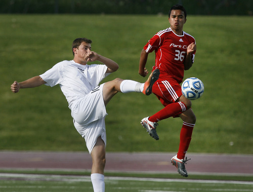 Scott Sommerdorf   |  The Salt Lake Tribune
Chase Thompson of Desert Hills, left, battles with Park City's Salvador Ramirez. Park City defeated Desert Hills 2-1 in the 3A boys' soccer state semifinal, Friday, May 10, 2013. They advance to tomorrow's 3A final.