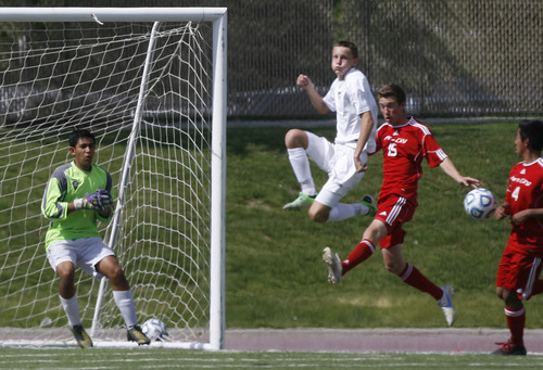Scott Sommerdorf   |  The Salt Lake Tribune
Desert Hills goalkeeper Vincent Enfield, left, watches as Park City's Brad Mulick, right tries to connect with a corner kick during first half play. Park City defeated Desert Hills 2-1 in the 3A boys' soccer state semifinal, Friday, May 10, 2013. They advance to tomorrow's 3A final.