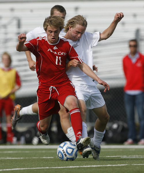Scott Sommerdorf   |  The Salt Lake Tribune
Will McFarland of Park City, left battles for the ball during first half play. Park City defeated Desert Hills 2-1 on McFarland's goal in the 3A boys' soccer state semifinal, Friday, May 10, 2013. They advance to tomorrow's 3A final.